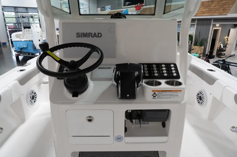 Slide: The Image of 2024 Caymas 281 HB boat console with Simrad electronics and Mercury controls. - 8