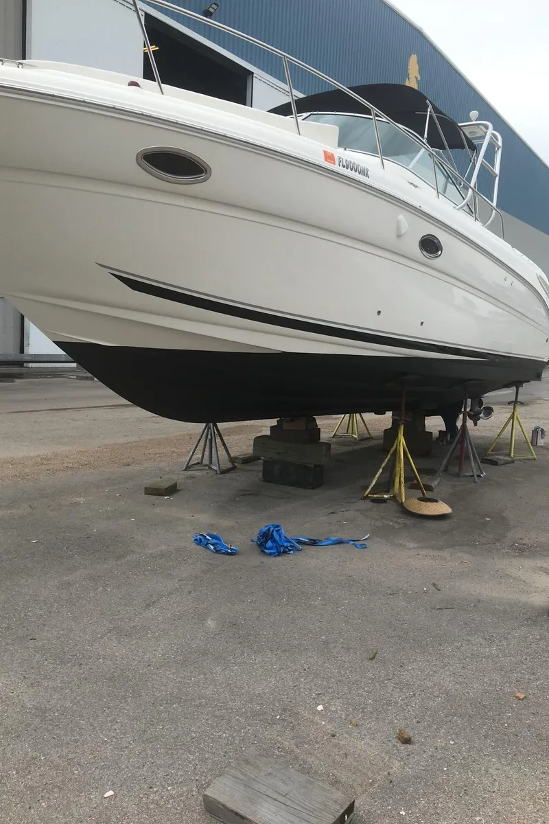 Slide: The Image of 2006 Sea Ray 290 Amberjack boat on stands for maintenance. - 11