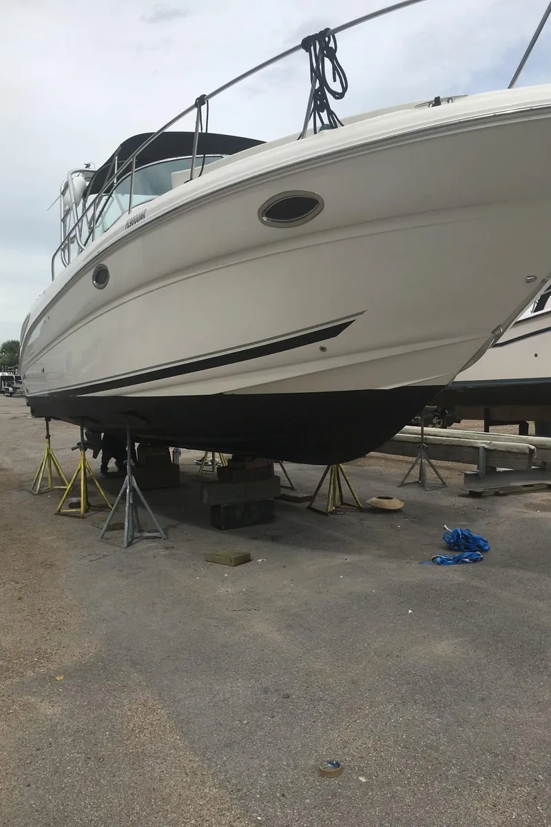 Slide: The Image of 2006 Sea Ray 290 Amberjack boat on stands for maintenance. - 14