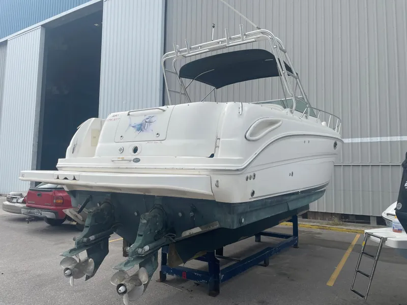 Slide: The Image of 2006 Sea Ray 290 Amberjack boat on a trailer outside a warehouse. - 16