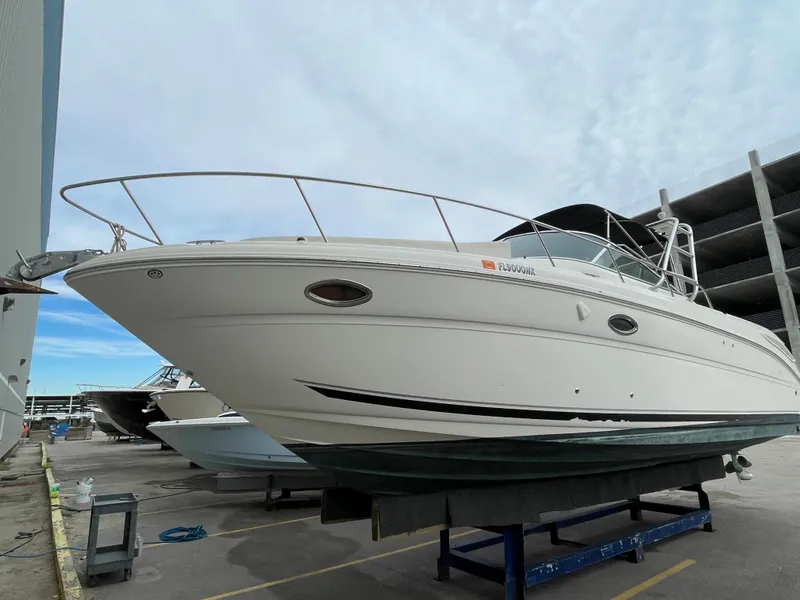 Slide: The Image of 2006 Sea Ray 290 Amberjack boat on display in a marina setting. - 20