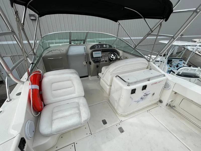 Slide: The Image of 2006 Sea Ray 290 Amberjack boat interior with seating and steering console. - 21