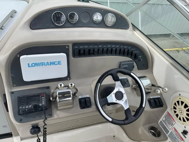 Slide: The Image of 2006 Sea Ray 290 Amberjack helm with Lowrance electronics and steering wheel. - 22