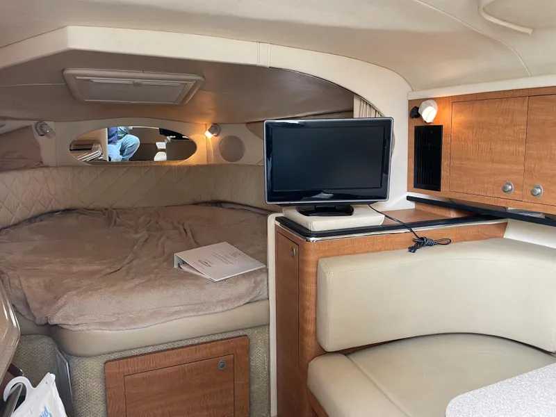 Slide: The Image of Interior of 2006 Sea Ray 290 Amberjack with cozy cabin and TV. - 24