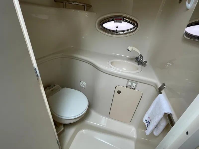 Slide: The Image of 2006 Sea Ray 290 Amberjack bathroom with sink, toilet, and towel rack. - 26