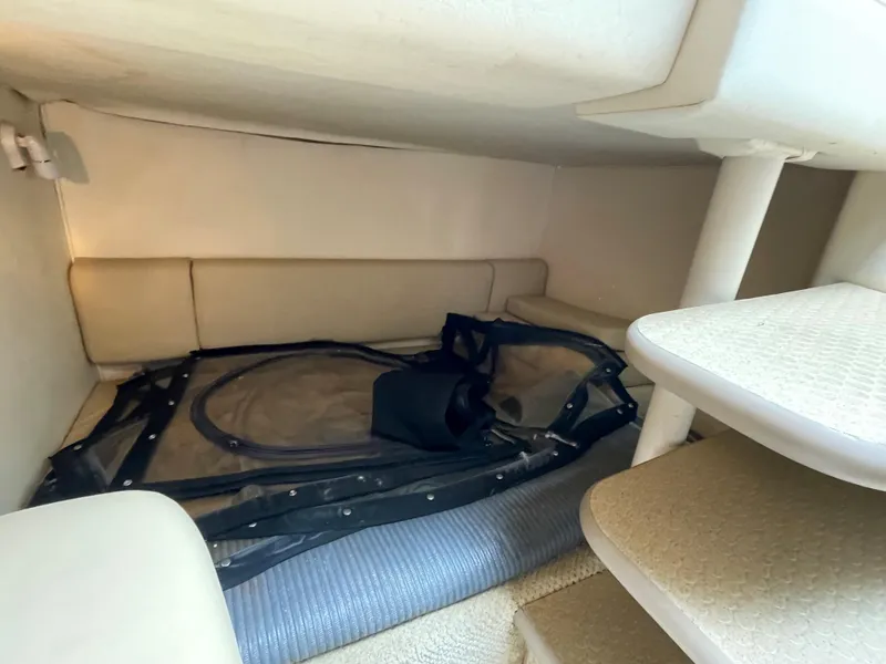 Slide: The Image of 2006 Sea Ray 290 Amberjack cabin interior with seating and storage space. - 28