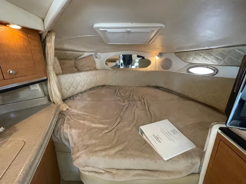 Slide: The Image of Cozy cabin interior of 2006 Sea Ray 290 Amberjack with plush bedding and wood accents. - 30
