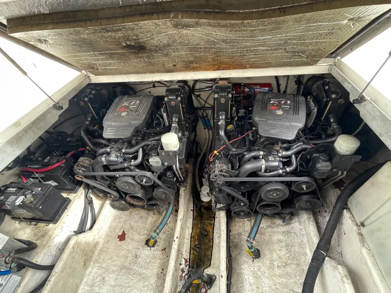 Slide: The Image of 2006 Sea Ray 290 Amberjack engine compartment with dual engines and battery. - 31