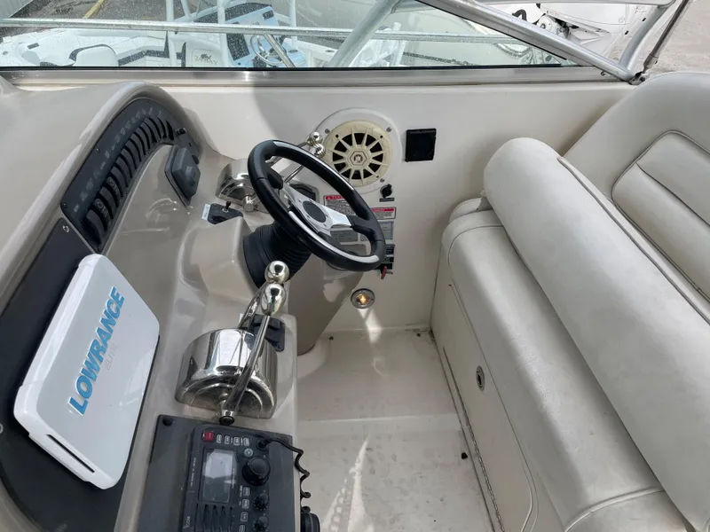 Slide: The Image of 2006 Sea Ray 290 Amberjack helm with steering wheel and navigation equipment. - 33