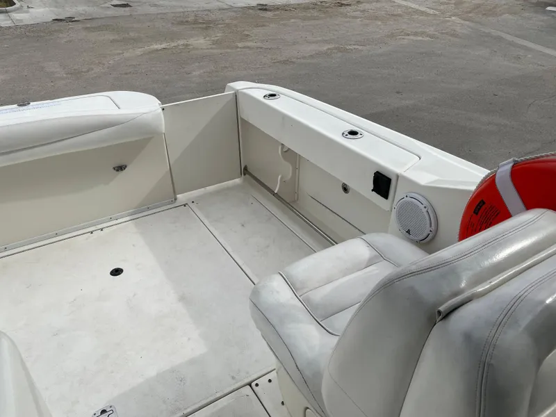 Slide: The Image of 2006 Sea Ray 290 Amberjack boat interior with white seating and storage compartments. - 35
