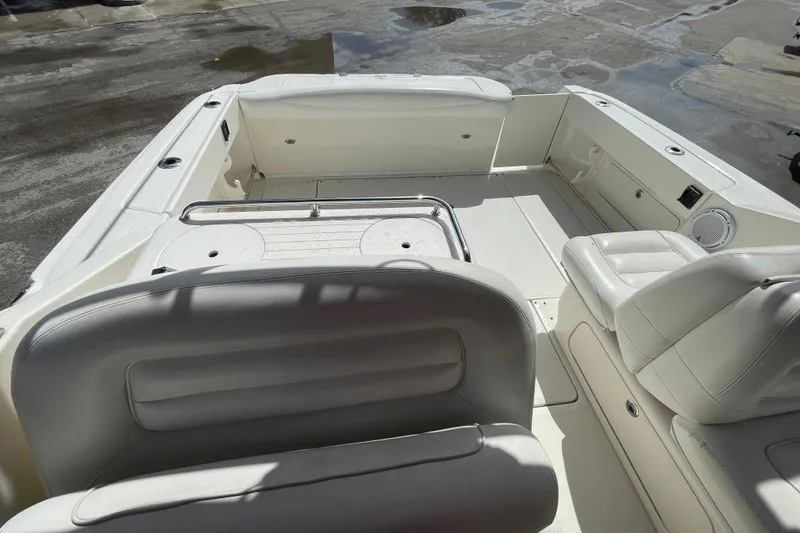 Slide: The Image of 2006 Sea Ray 290 Amberjack boat interior with white seating and spacious deck area. - 42