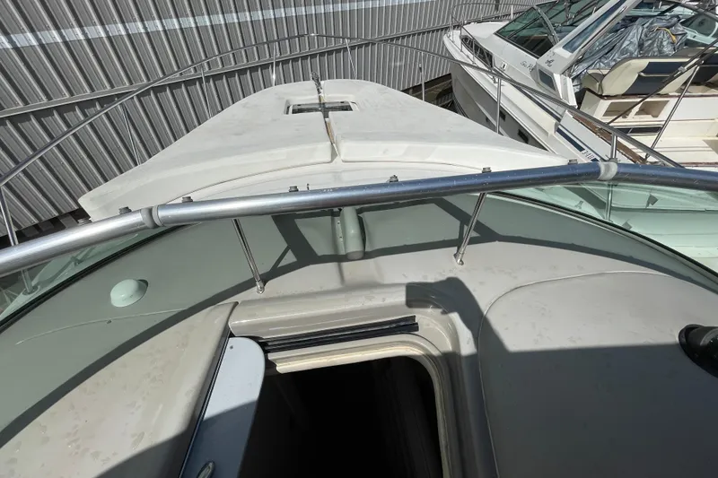 Slide: The Image of 2006 Sea Ray 290 Amberjack boat deck with railing and open hatch. - 43