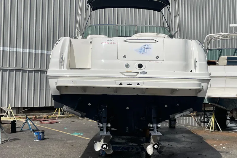 Slide: The Image of 2006 Sea Ray 290 Amberjack boat in dry dock, rear view with dual propellers. - 45