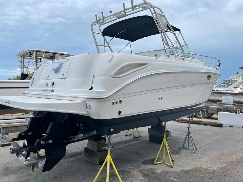 Slide: The Image of 2006 Sea Ray 290 Amberjack boat on stands, white hull, out of water. - 5