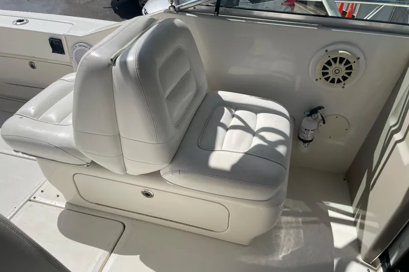 Slide: The Image of White leather seating on 2006 Sea Ray 290 Amberjack boat, featuring speaker and fire extinguisher. - 56