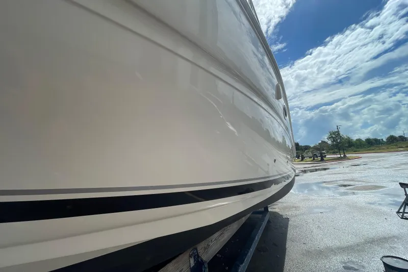 Slide: The Image of 2006 Sea Ray 290 Amberjack boat side view under clear blue sky. - 58