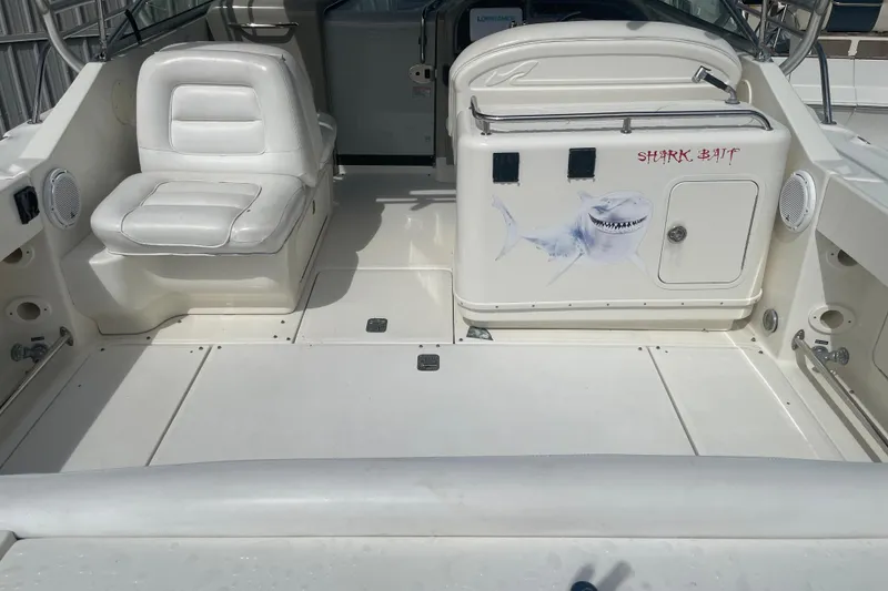 Slide: The Image of 2006 Sea Ray 290 Amberjack boat interior with white seating and shark graphic. - 59