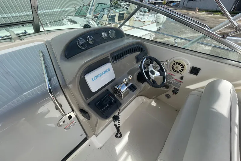 Slide: The Image of 2006 Sea Ray 290 Amberjack helm with steering wheel, gauges, and Lowrance navigation system. - 60