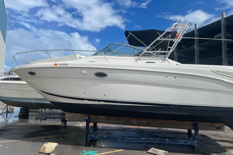 Slide: The Image of 2006 Sea Ray 290 Amberjack boat on dry dock under blue sky. - 64