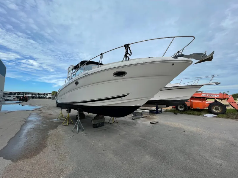 Slide: The Image of 2006 Sea Ray 290 Amberjack boat on stands in a marina. - 9