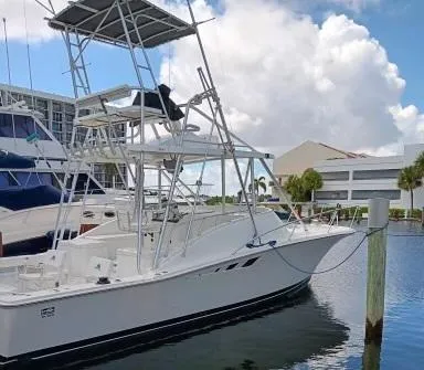 The Image of 1995 Luhrs 32 Tournament Open boat docked at marina with blue sky background. - 1