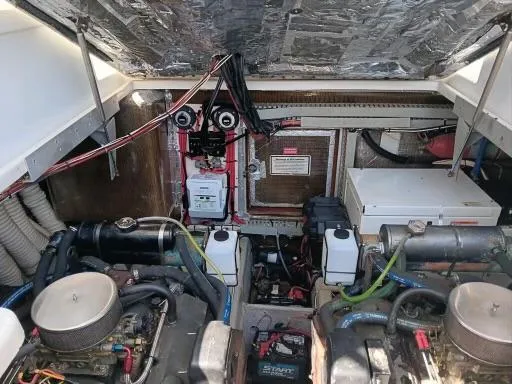 Slide: The Image of 1995 Luhrs 32 Tournament Open engine compartment with dual engines and wiring. - 13