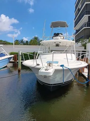 Slide: The Image of 1995 Luhrs 32 Tournament Open boat docked in marina. - 2