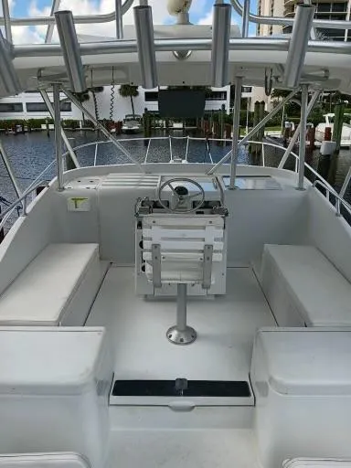 Slide: The Image of 1995 Luhrs 32 Tournament Open boat cockpit with seating and steering console. - 6