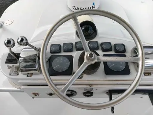 Slide: The Image of 1995 Luhrs 32 Tournament Open boat helm with Garmin navigation system. - 7