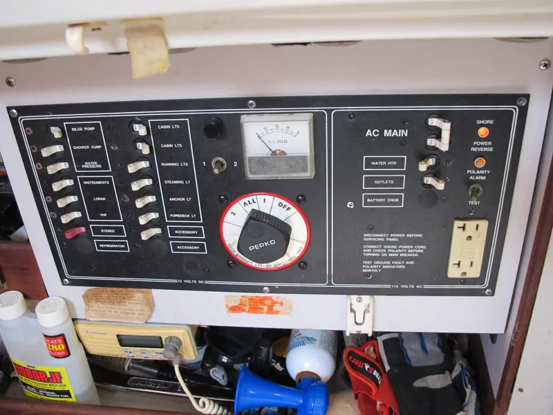 Slide: The Image of 1987 O'Day 322 electrical control panel with switches and AC main. - 14