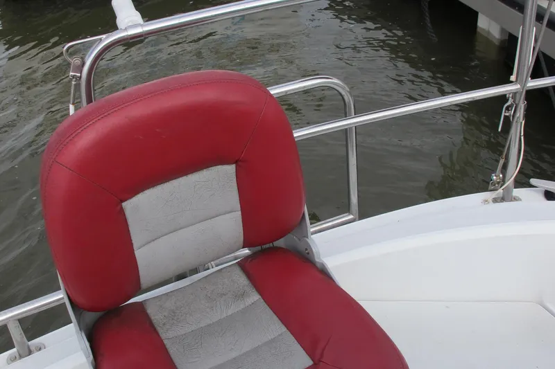 Slide: The Image of Red and gray seat on 1987 O'Day 322 boat, docked by water. - 19