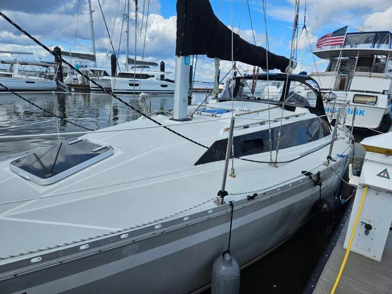 Slide: The Image of 1987 O'Day 322 sailboat docked at a marina with other boats. - 2