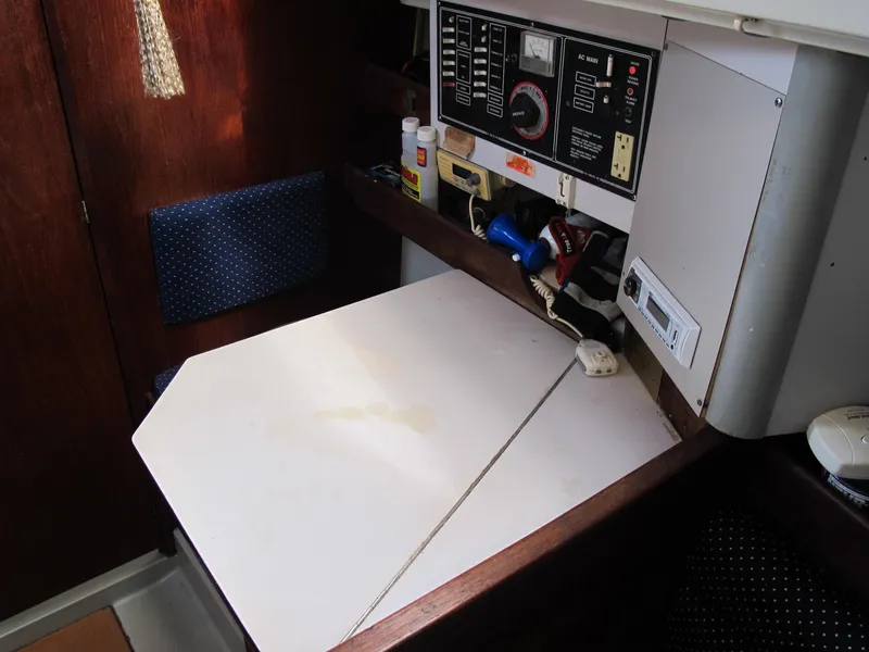 Slide: The Image of 1987 O'Day 322 sailboat navigation station with control panel and storage. - 23