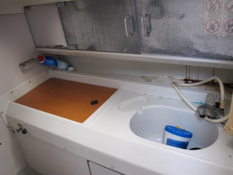 Slide: The Image of 1987 O'Day 322 boat galley with sink and storage cabinets - 34
