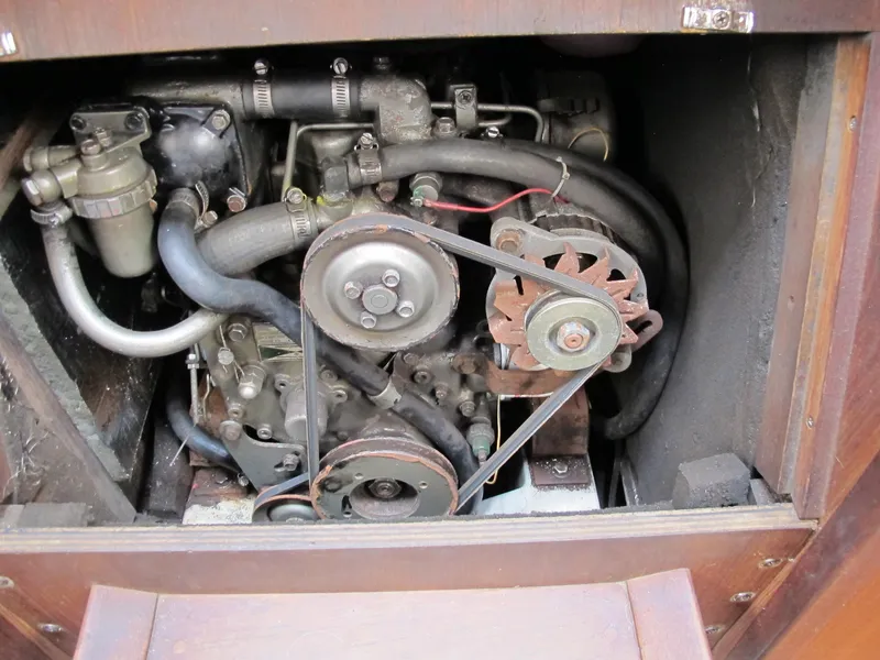 Slide: The Image of 1987 O'Day 322 engine compartment with visible belts and hoses. - 38