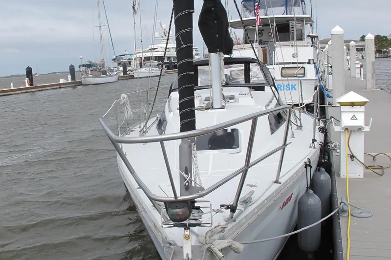 Slide: The Image of 1987 O'Day 322 sailboat docked at a marina, front view. - 6