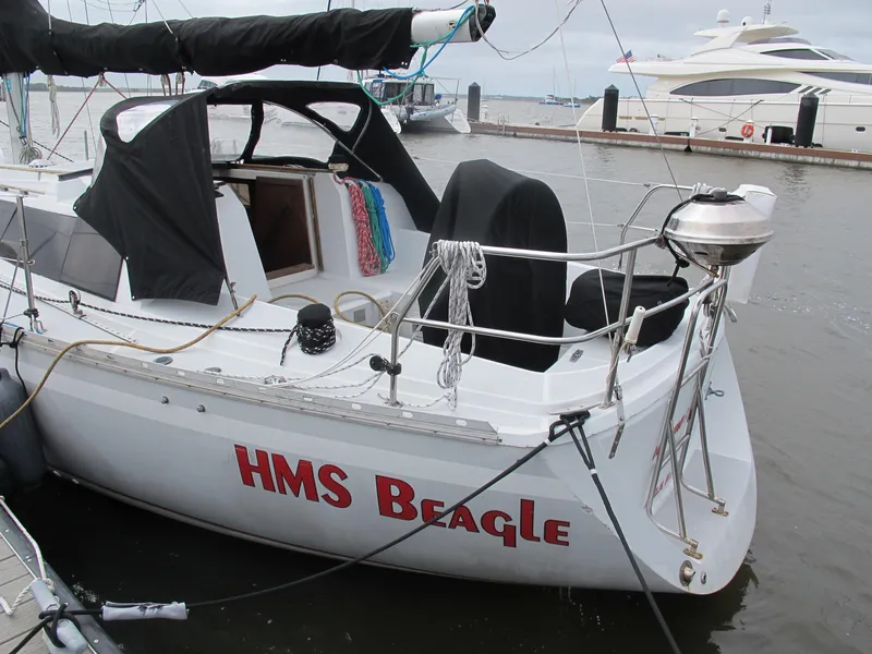Slide: The Image of 1987 O'Day 322 sailboat named HMS Beagle docked at a marina. - 8