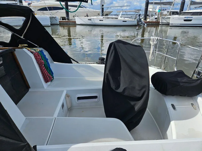 Slide: The Image of 1987 O'Day 322 sailboat cockpit at marina with covered seats. - 9