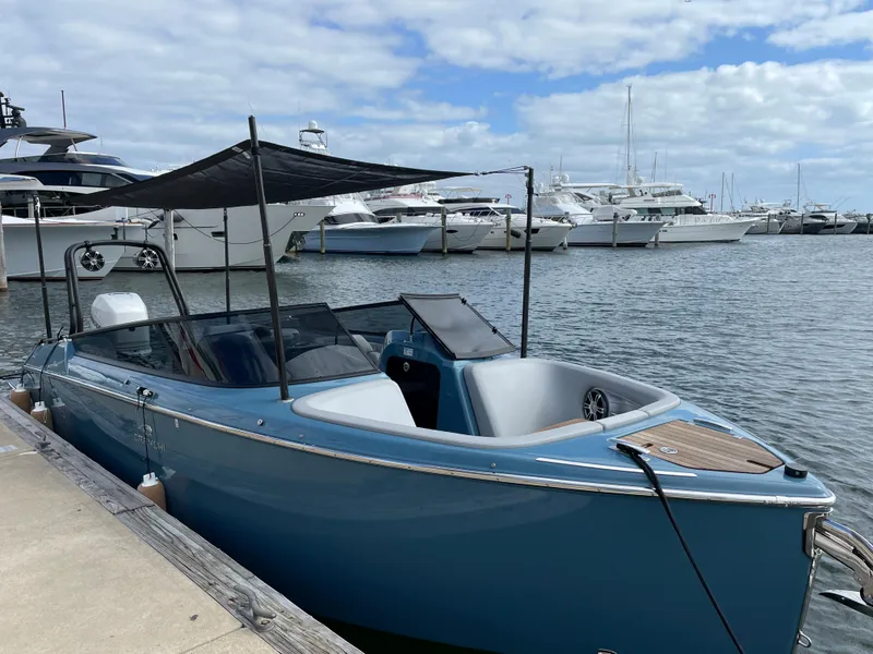 Slide: The Image of 2022 Cranchi 26 Rider boat docked at marina with other yachts in background. - 0