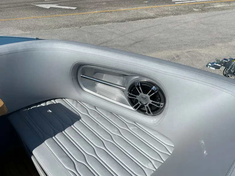 Slide: The Image of Interior of 2022 Cranchi 26 Rider boat with speaker and cushioned seating. - 12