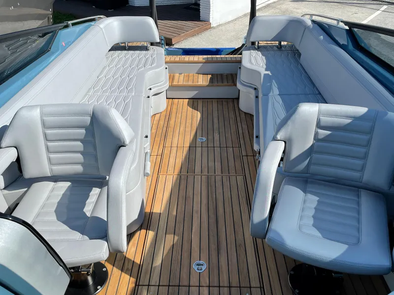 Slide: The Image of 2022 Cranchi 26 Rider boat interior with sleek gray seating and wooden flooring. - 18