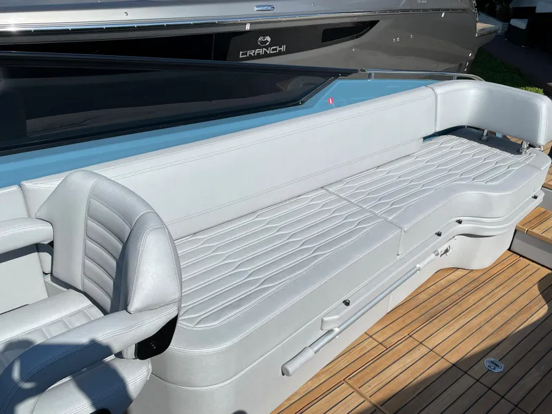 Slide: The Image of Luxurious seating on 2022 Cranchi 26 Rider boat with sleek design and wooden deck. - 20