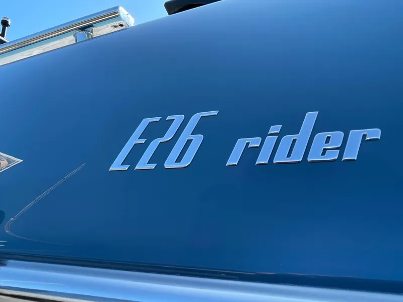 Slide: The Image of Cranchi 26 Rider 2022 boat logo on sleek blue surface. - 22