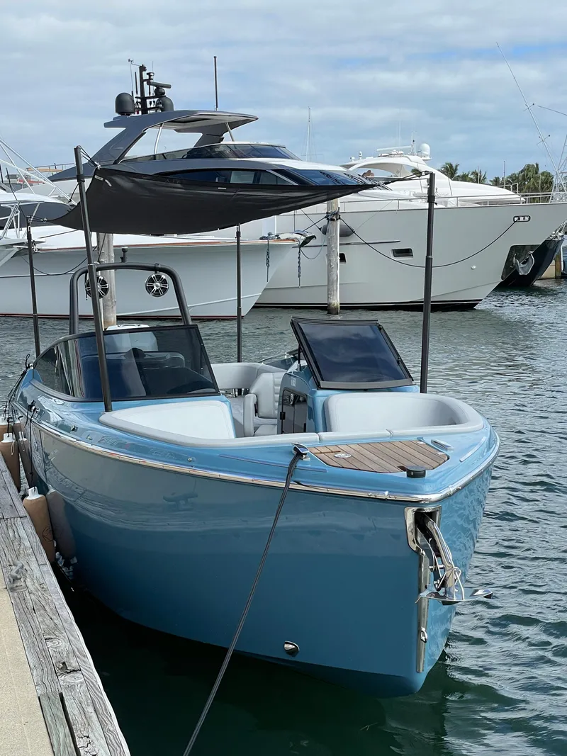 Slide: The Image of 2022 Cranchi 26 Rider boat docked at marina, featuring sleek design and modern amenities. - 23