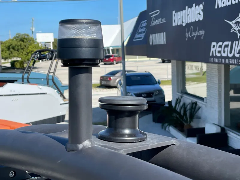 Slide: The Image of Navigation light and cleat on 2022 Cranchi 26 Rider boat, outdoor dealership setting. - 29