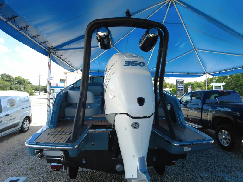 Slide: The Image of 2022 Cranchi 26 Rider boat with 350 horsepower engine under blue canopy. - 37