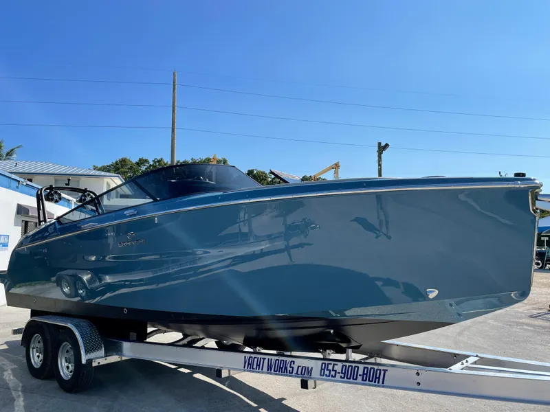 Slide: The Image of 2022 Cranchi 26 Rider boat on trailer under clear blue sky. - 38