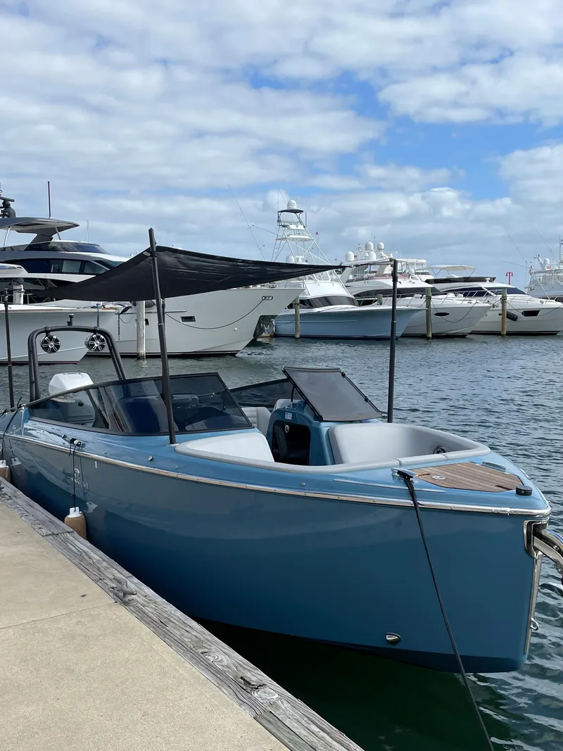 Slide: The Image of 2022 Cranchi 26 Rider boat docked at marina with other yachts. - 4