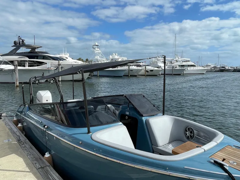Slide: The Image of 2022 Cranchi 26 Rider boat docked at marina with yachts in background. - 5