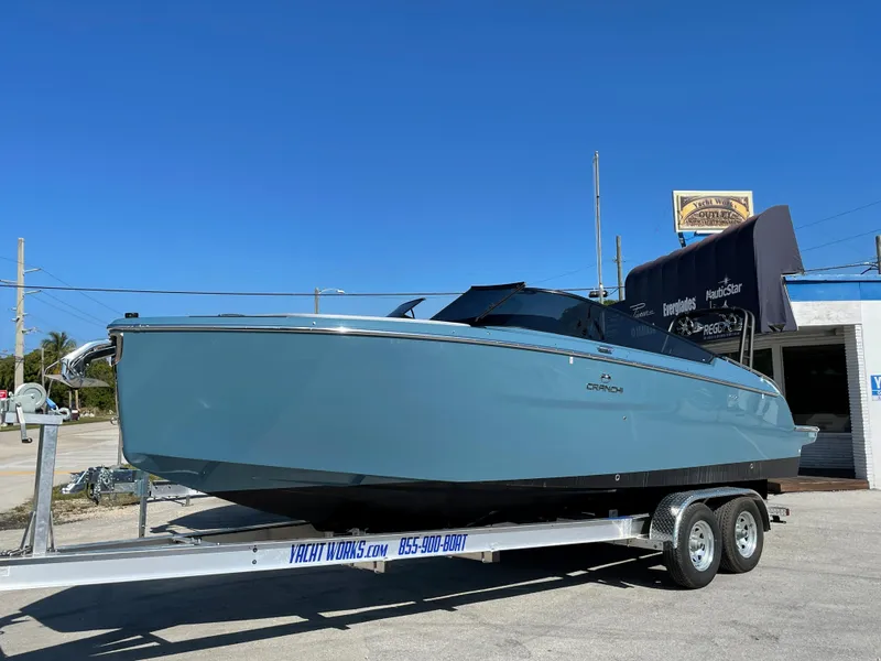 Slide: The Image of 2022 Cranchi 26 Rider boat on trailer under clear blue sky. - 6